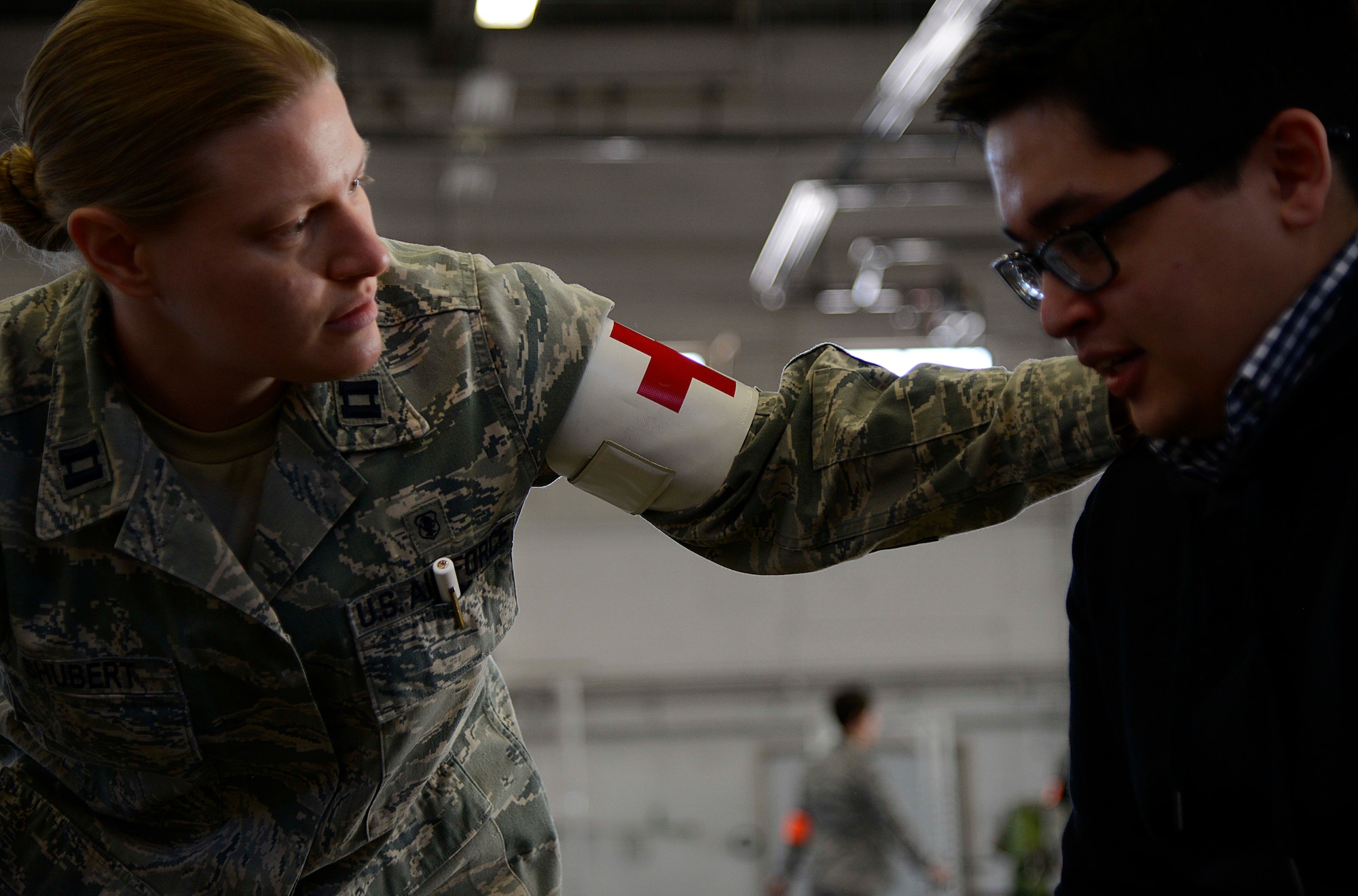 Air Force Capt. Danielle Shubert, 673d Medical Operations Squadron pediatric clinical nurse, tends to Airman Garrett Hilde, 732nd Air Mobility Squadron passenger service agent, after he showed symptoms of an "asthma attack" during Exercise Polar Force 14-2 noncombatant evacuation operations, Feb. 5,2014 at Joint Base Elmendorf-Richardson, Alaska.  Garrett played a NEO evacuee during the exercise. The primary focus of a NEO is designed to quickly move U.S. citizens from a dangerous region to a safe haven or U.S. soil. (U.S. Air Force photo/Staff Sgt. Sheila deVera)