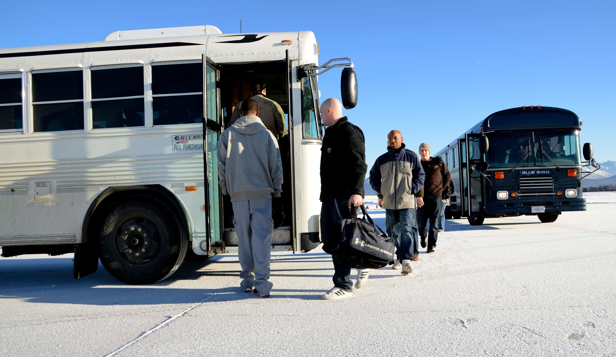 Simulated evacuees from the 673d Air Base Wing transit from a bus, which simulated a C-17 Globemaster III, to a shuttle which will take them to the noncombatant reception control center during Exercise Polar Force 14-2, Feb. 5, 2014, Joint Base Elmendorf-Richardson, Alaska. The exercise tested the ability of the base noncombatant reception control center personnelsÕ ability to account for and process the personnel. (U.S. Air Force photo/Staff Sgt. Sheila deVera)