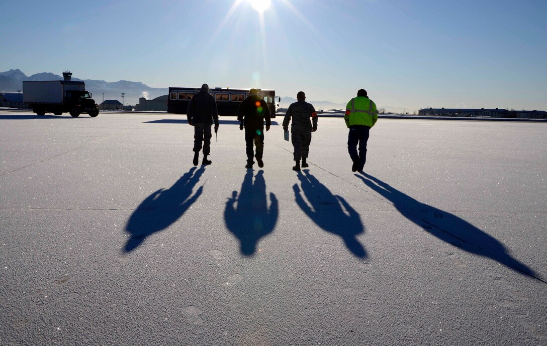 Members from Joint Base Elmendorf-Richardson's Wing Inspection Team approach a bus which is used to simulate a C-17 Globemaster III during Exercise Polor Force 14-2 noncombatant evacuation operations, Feb. 5, 2014, JBER Alaska. WIT members provide the wing commander with an unbiased assessment of the wingÕs ability to execute the mission. (U.S. Air Force photo/Staff Sgt. Sheila deVera) 