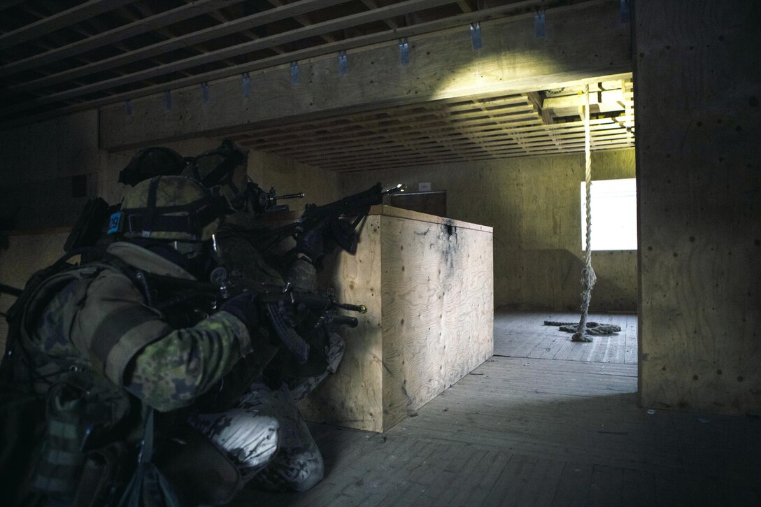 Two Finnish soldiers post security on a breach in the ceiling while Marines prepare to repel into the room and clear the building from the attic to the ground level during a Military Operations in Urban Terrain Instructor’s course in Helsinki, Finland, Jan. 23, 2014. The two-week long course focused on tactical movement in an urban environment, room breaching and clearing, combat lifesaving and medical evacuations, detainee handling, and live-fire ranges. The training and partnership between the U.S. and Finnish forces proved to be an integral part of BSRF-14’s mission of maintaining and further strengthening close-and-solid relationships while promoting regional stability and increasing interoperability with partner nations in the region.

