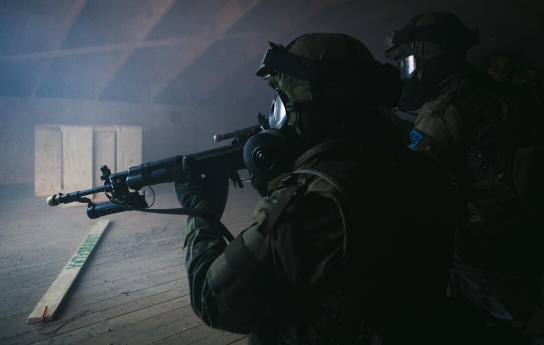 Two Finnish soldiers post security in the attic of a building while Marines prepare to repel into the room through a breach in the ceiling and clear the building down to the ground level during a Military Operations in Urban Terrain Instructor’s course in Helsinki, Finland, Jan. 23, 2014. The two-week long course focused on tactical movement in an urban environment, room breaching and clearing, combat lifesaving and medical evacuations, detainee handling, and live-fire ranges. The training and partnership between the U.S. and Finnish forces proved to be an integral part of BSRF-14’s mission of maintaining and further strengthening close-and-solid relationships while promoting regional stability and increasing interoperability with partner nations in the region.