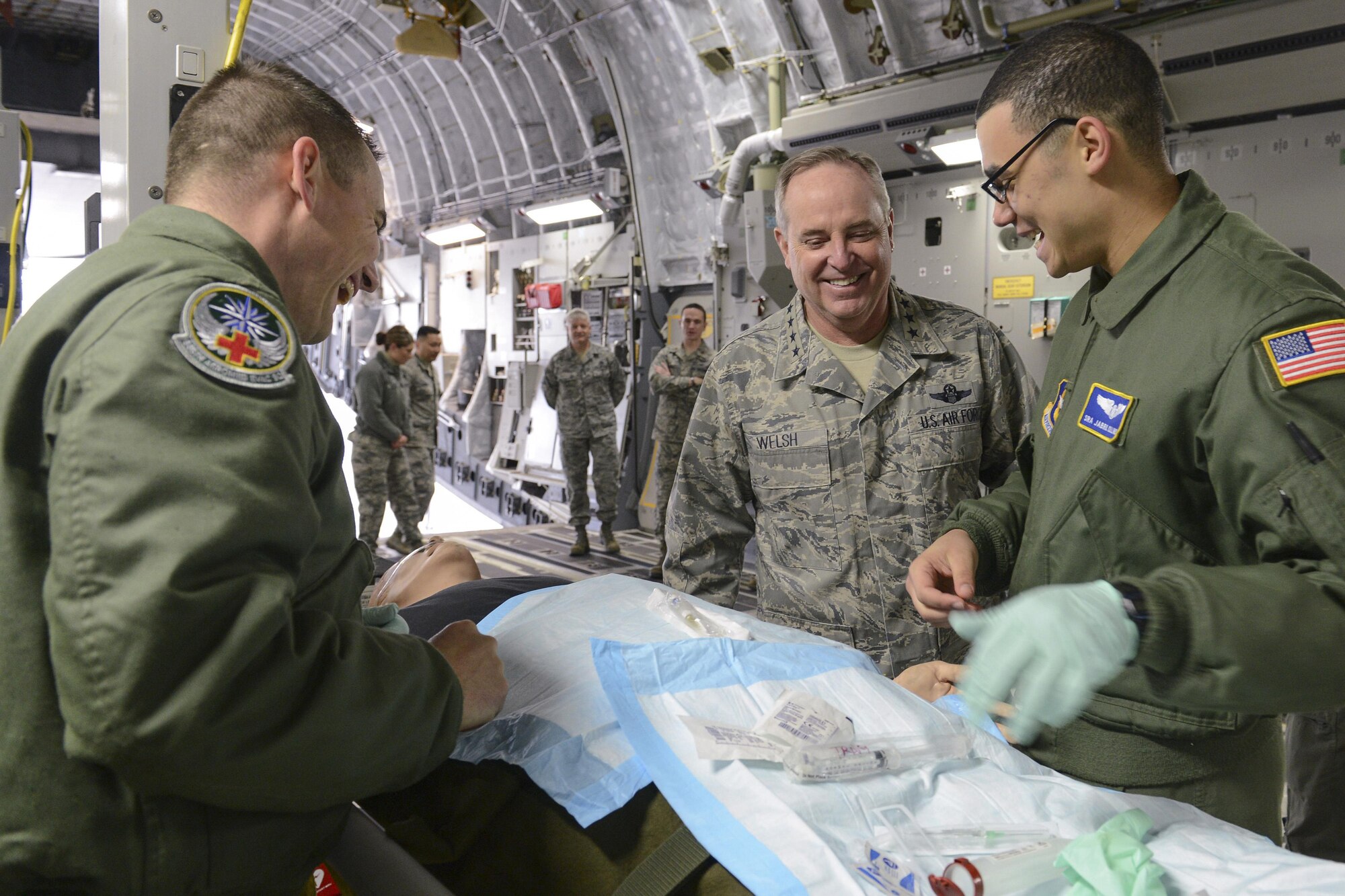 Senior Airman Elijah Burns, left, and Senior Airman Jabril Collins, 446th Aeromedical Evacuation Squadron aeromedical evacuation technicians, perform an IV insertion patient training scenario demonstration for Air Force Chief of Staff Gen. Mark A. Welsh III, Feb. 3, 2014, at Joint Base Lewis-McChord, Wash. Welsh joked with the Airmen, stating that he was glad the "patient" was in their care and not his. (U.S. Air Force photo/Tech. Sgt. Sean Tobin)