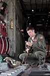 U.S. Air Force Senior Airman Nick J. Barth, an aircraft loadmaster with the 169th Airlift Squadron, packs a training bundle on a C-130 Hercules at Alpena, Mich., in support of Exercise Northern Strike 2013 on Aug. 7, 2013. His father also worked in the exercise.