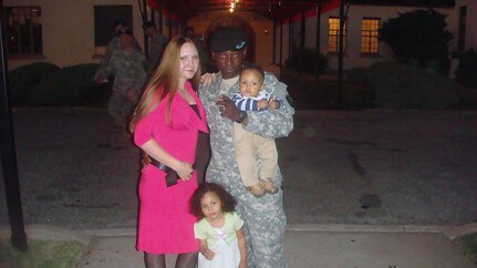 Wilson Ugah, then a 2nd lieutenant in the California Army National Guard, attends a family appreciation event with his wife, Olga, and children, Sofia and Rian, at Fort Sill, Okla., in 2010.