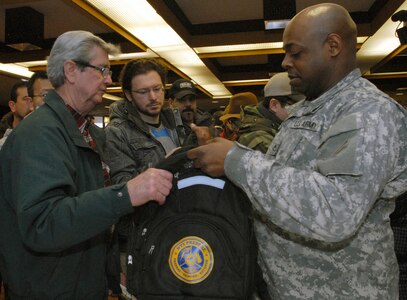 New York Army National Guard Pfc. Edwin Olivera distributes disaster and emergency response starter kits at the launch of New York Gov. Andrew Cuomo's Citizen Preparedness Corps Training Program on Feb. 1. New York National Guard troops gave disaster and emergency training to more than 1,200 people who attended events at New Dorp High School here and in Suffolk County.