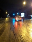 A Georgia National Guard member, one of several activated early Jan. 29, 2014, stands on roadway covered in icy slop.