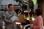Sgt. 1st Class Brian Brower talks with a representative from one of several agencies geared toward financial readiness that took part in the Military Saves kick off event at the Army National Guard Readiness Center in Arlington, Va., Thursday, Jan. 30, 2014.