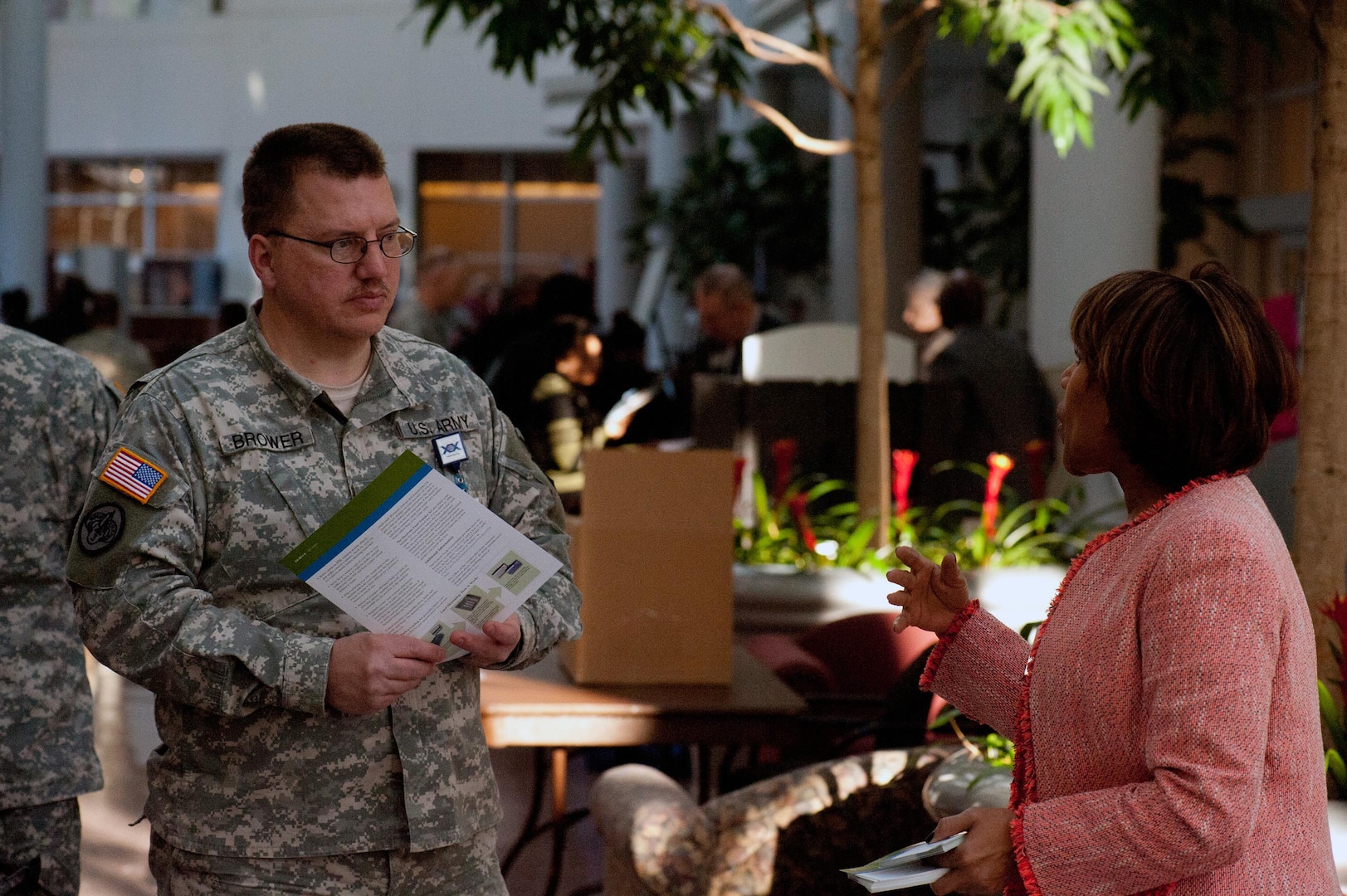 Sgt. 1st Class Brian Brower talks with a representative from one of several agencies geared toward financial readiness that took part in the Military Saves kick off event at the Army National Guard Readiness Center in Arlington, Va., Thursday, Jan. 30, 2014.