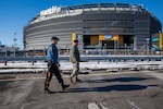 Staff Sgt. Jonathan Arochas, of the New Jersey National Guard's 108th Wing, monitors the perimeter of MetLife Stadium along with a New Jersey state trooper ahead of Super Bowl XLVIII. Guardsmen from six states are on duty supporting the event.
