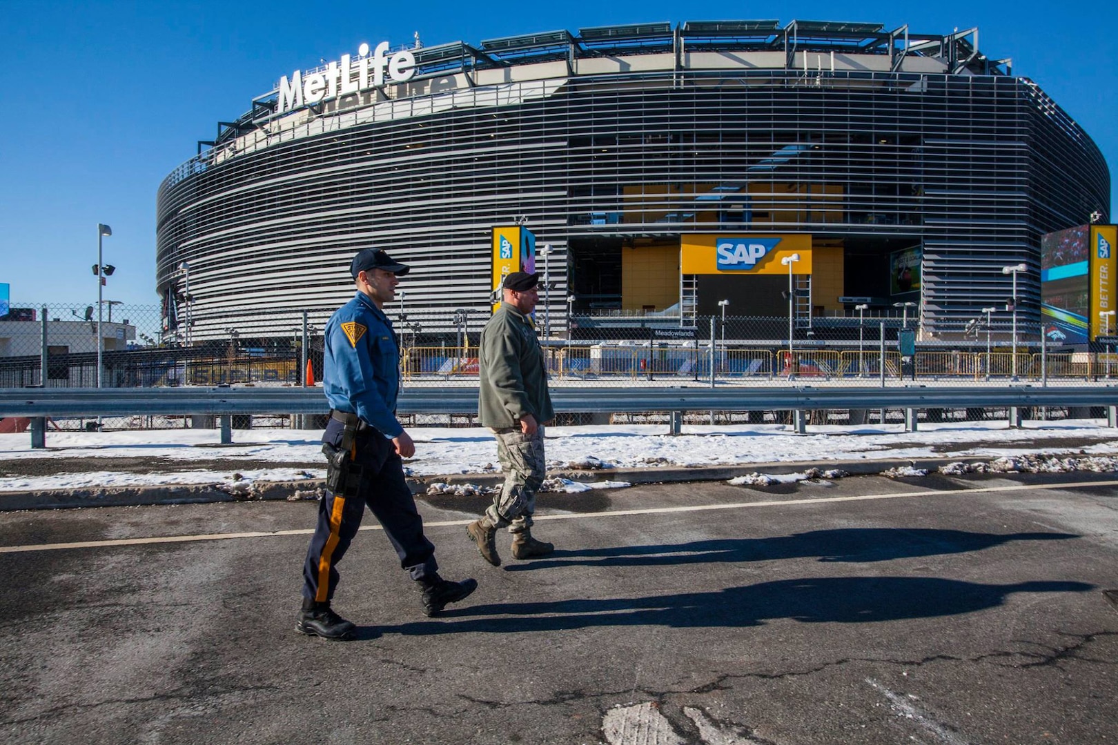 Staff Sgt. Jonathan Arochas, of the New Jersey National Guard's 108th Wing, monitors the perimeter of MetLife Stadium along with a New Jersey state trooper ahead of Super Bowl XLVIII. Guardsmen from six states are on duty supporting the event.