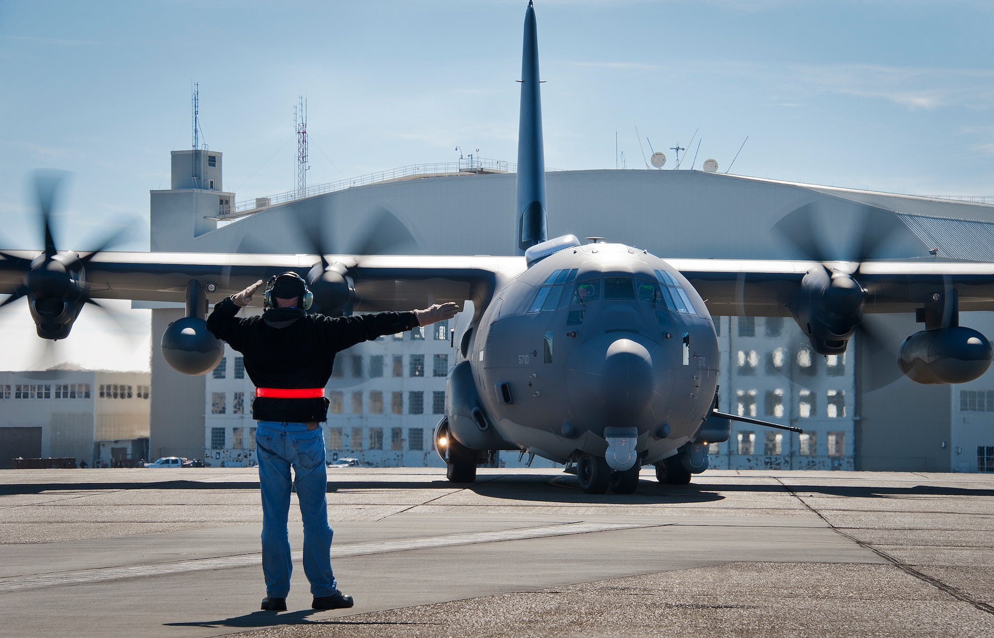 Dave King, of Lockheed Martin, marshals out the AC-130J Ghostrider as it taxis the runway for its first official sortie Jan. 31 at Eglin Air Force Base, Fla. The Air Force Special Operations Command MC-130J arrived at Eglin in January 2013 to begin the modification process for the AC-130J, whose primary mission is close air support, air interdiction and armed reconnaissance. A total of 32 MC-130J prototypes will be modified as part of a $2.4 billion AC-130J program to grow the future fleet. (U.S. Air Force photo/Chrissy Cuttita) 