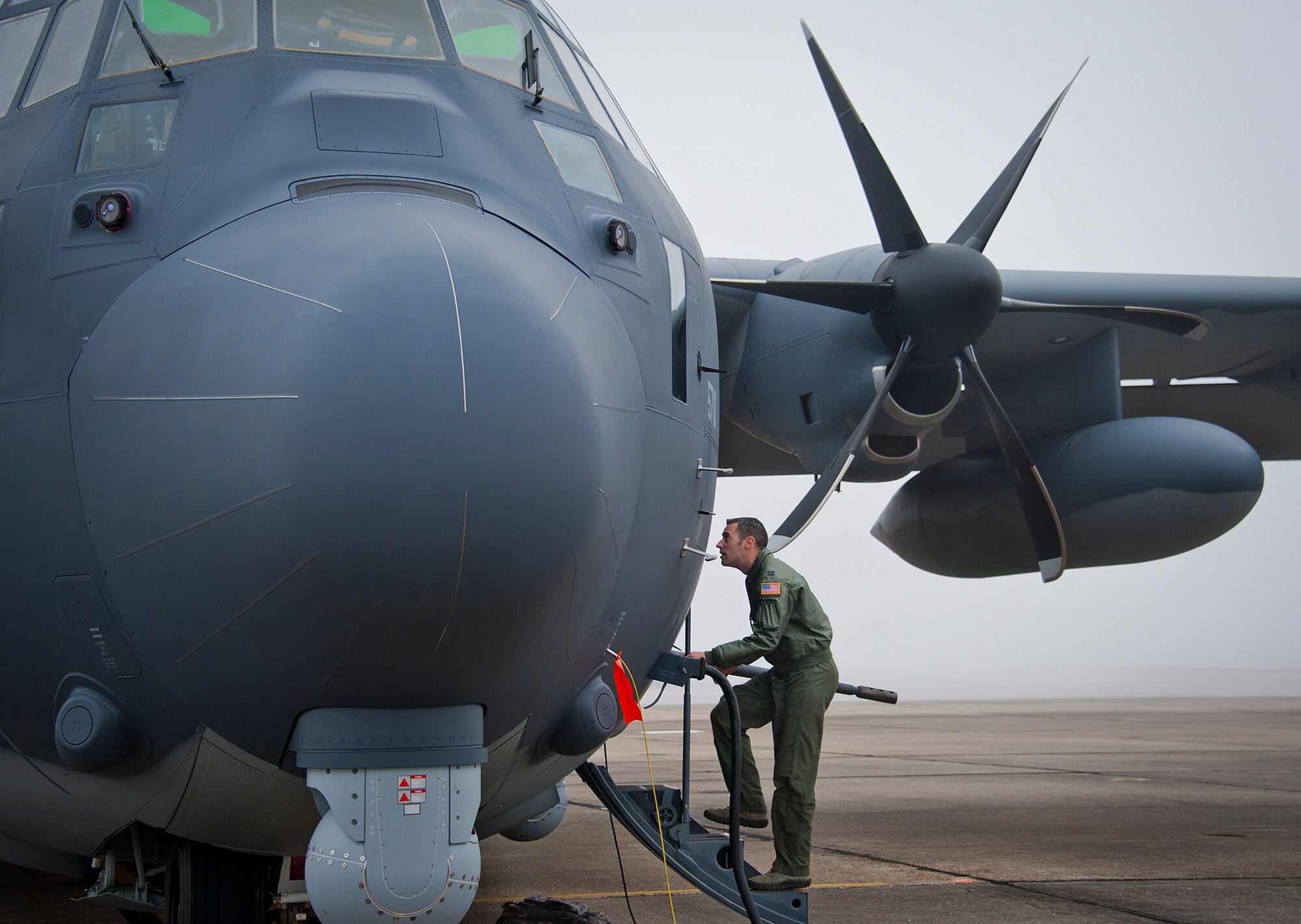 Capt. Steve Visalli, a flight test engineer with the 413th Flight Test Squadron, boards the newly created AC-130J Ghostrider in anticipation of its first official sortie Jan. 31 at Eglin Air Force Base, Fla. The Air Force Special Operations Command MC-130J arrived at Eglin in January 2013 to begin the modification process for the AC-130J, whose primary mission is close air support, air interdiction and armed reconnaissance. A total of 32 MC-130J prototypes will be modified as part of a $2.4 billion AC-130J program to grow the future fleet. (U.S. Air Force photo/Chrissy Cuttita) 