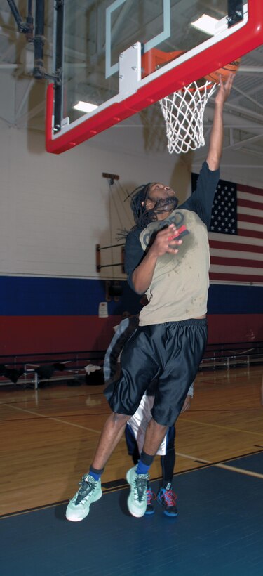JaVoris Bland, son of Kurt Bland, deputy director, Communications and Information Systems Division, Marine Corps Logistics Base Albany, goes up for a left-handed lay-up during a recent pickup basketball game at Thomason Gymnasium, here.
