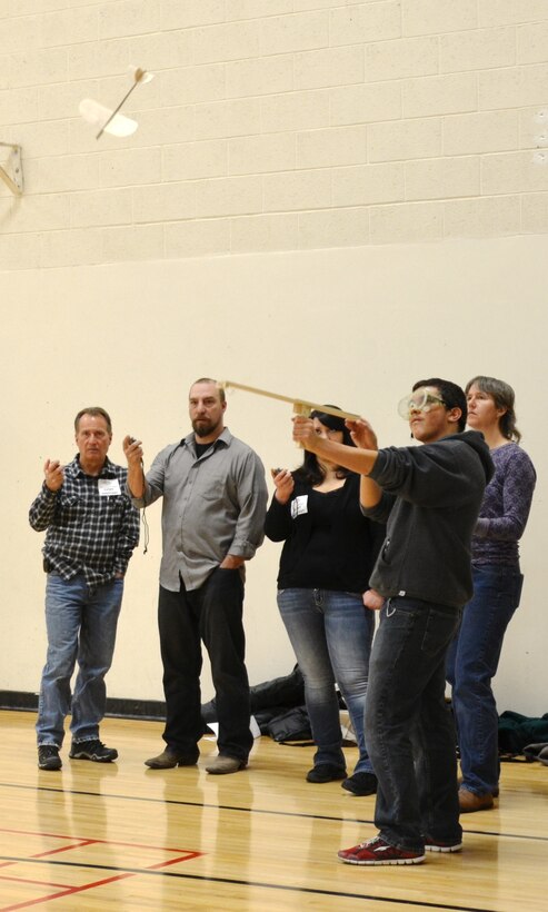 ALBUQUERQUE, N.M., -- (l-r) Jeff Firebaugh, Chris Parrish, and Ariane Pinson (right) time a student's glider during the "Elastic-Launched Glider" event at the Central New Mexico Regional Science Olympiad, Feb. 1. 

