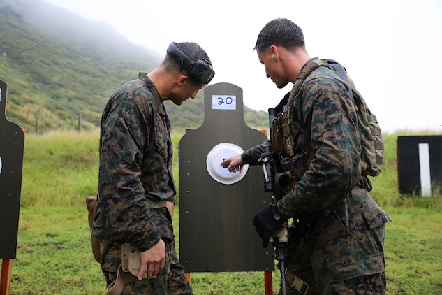 Gunnery Sgt. Jeremiah Dare (left), the Bravo Company operations chief for 3rd Reconnaissance Battalion, coaches Sgt. David Tanney, the jump team leader with Bravo Co., 3rd Recon Bn., during marksmanship training at Kaneohe Bay Range Training Facility, Feb. 4, 2014. (U.S. Marine Corps photo by Lance Cpl. Suzanna Knotts) 