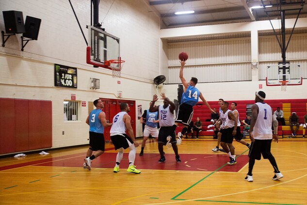 A player with 3rd Radio Battalion attempt to take a shot during a game in the third week of the intramural basketball season at the Semper Fit Center gym, Feb. 4, 2014. Despite a comeback effort, the team lost to Marine Aviation Logistics Squadron 24 by a score of 49-39. (U.S. Marine Corps photo by Lance Cpl. Matthew Bragg)