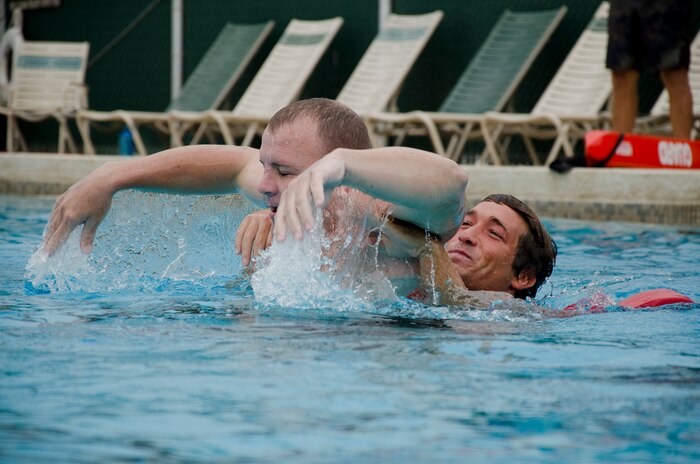 John Pruitt (left) pretends to be an “active drowner” while Danny Jones practices a life-saving technique during a lifeguard class at the base pool, Feb. 3, 2014. Pruitt, a Marine Corps instructor in water survival, took the class to be re-certified in first aid and CPR. Marine Corps Community Services aquatics offers American Red Cross lifeguard certification and swimming lessons for all ages. (U.S. Marine Corps photo by Kristen Wong)