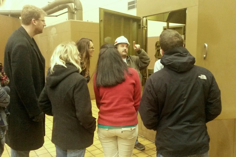 Surrounded by towering generating units within the power house, Chris Sherek, power house operator, speaks about how each generating hydropower unit's speed is controlled to students from the Nashville General Hospital School of Radiology at Murrey Medical College during a tour Thursday, Feb. 6, 2014.