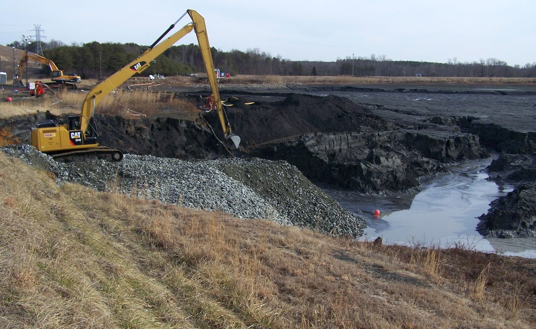 Heavy equipment operators place riprap stone at Duke Energy’s Dan River Power Plant.  The stone is being placed in the interior of the coal ash retention pond to create a stable foundation to move heavy equipment in place to reach and seal the broken pipe.  The broken pipe will have concrete grout placed inside to form a plug and prevent additional coal ash from escaping. (USACE photo by Ben Lackey)