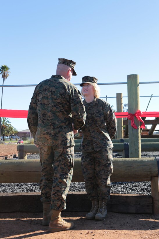 Cpl. Megan Scullin, a combat videographer with 3rd Marine Aircraft Wing (MAW) and a Troy, Mont., native, shakes Commanding General of 3rd MAW Maj. Gen. Steven Busby’s hand after being meritoriously promoted aboard Marine Corps Air Station Miramar, Calif., Jan. 6. Scullin attended the Corporals indoctrination and Corporals Course immediately following her promotion.