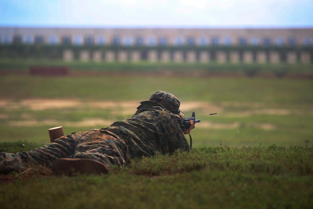 Lance Cpl. Quincy Gilliland, a bulk fuel specialist with Marine Corps Base Hawaii Fuels and a 22-year-old native of Liberty, N.C., fires his weapon in the prone position during the Pacific Division Shooting Competition on Puuloa Training Facility, Feb. 5, 2014. (U.S. Marine Corps photo by Cpl. Nathan Knapke) 