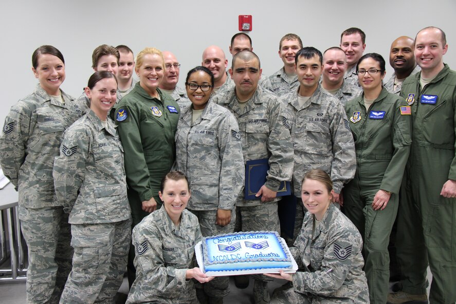 The newest graduates of the Air Force Reserve Command's noncommissioned officer leadership development course at the 932nd Airlift Wing enjoy their last day together with a cake to celebrate.  (U.S. Air Force photo/Maj. Stan Paregien)