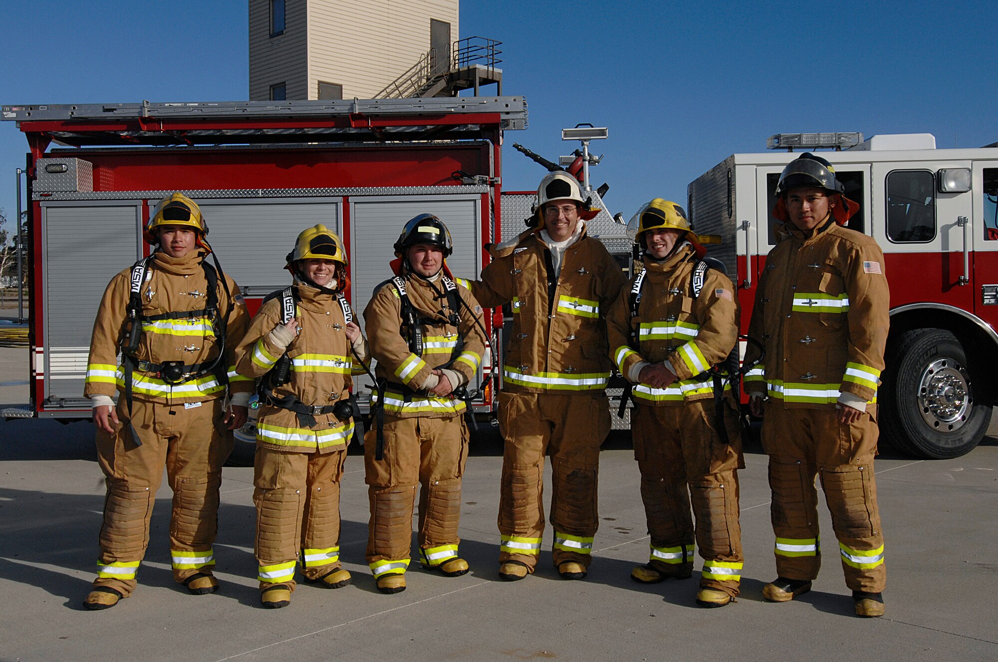 VANDENBERG AIR FORCE BASE, Calif. -- Col. Keith Balts, 30th Space Wing commander, and Airmen of the quarter winners stand ready to train with Vandenberg firefighters here Jan. 29. Balts and the airmen got the opportunity to work with the Vandenberg Firefighters during a burning building exercise (U.S. Air Force photo/Michael Peterson)