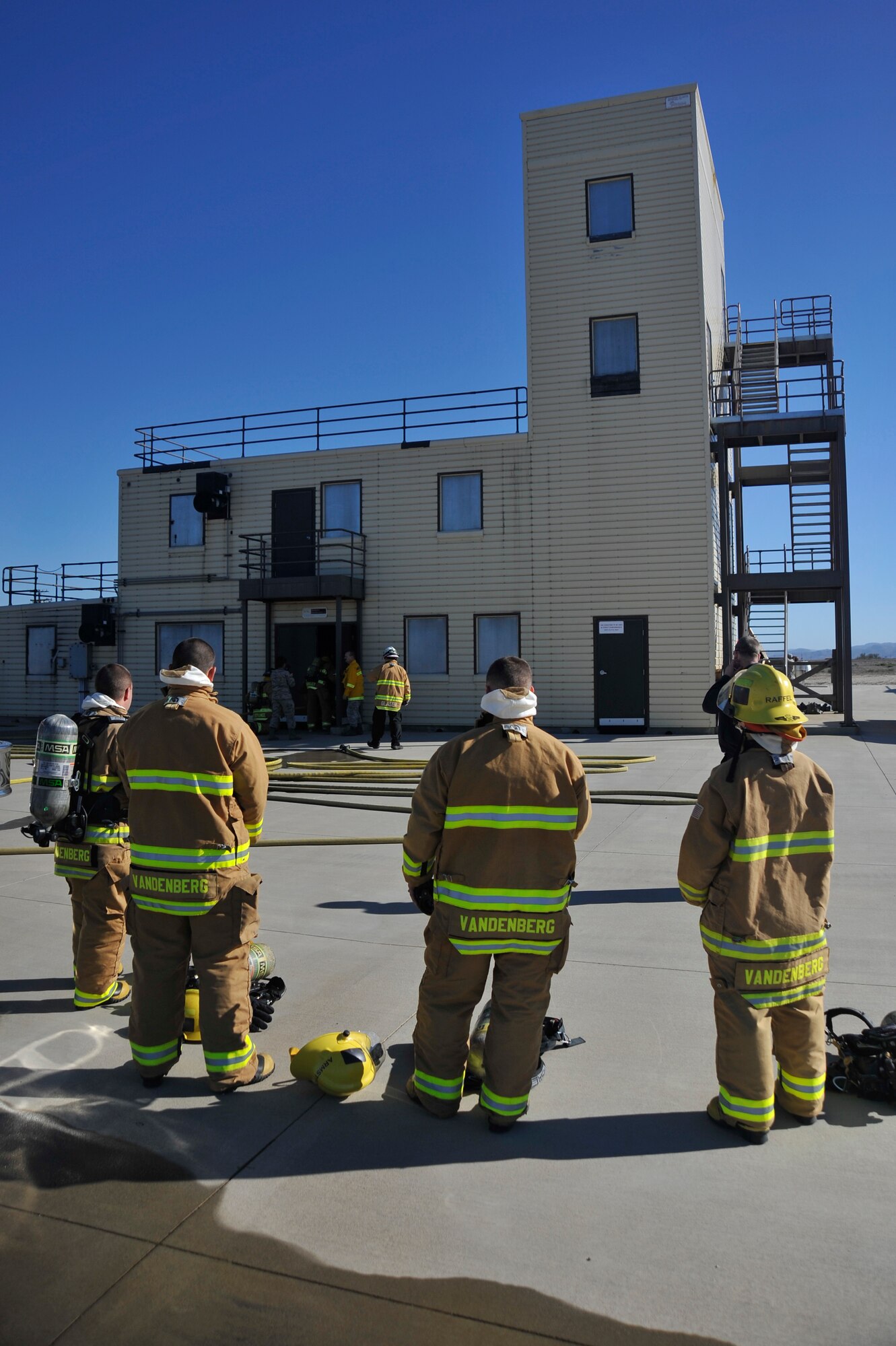 VANDENBERG AIR FORCE BASE, Calif. -- Vandenberg Airmen of the quarter prepare to enter a firefighter training facility here Jan. 29. Col. Keith Balts, 30th Space Wing commander, along with Airmen of the quarter winners, got the opportunity to work with the Vandenberg Firefighters during a burning building exercise. (U.S. Air Force photo/Michael Peterson)