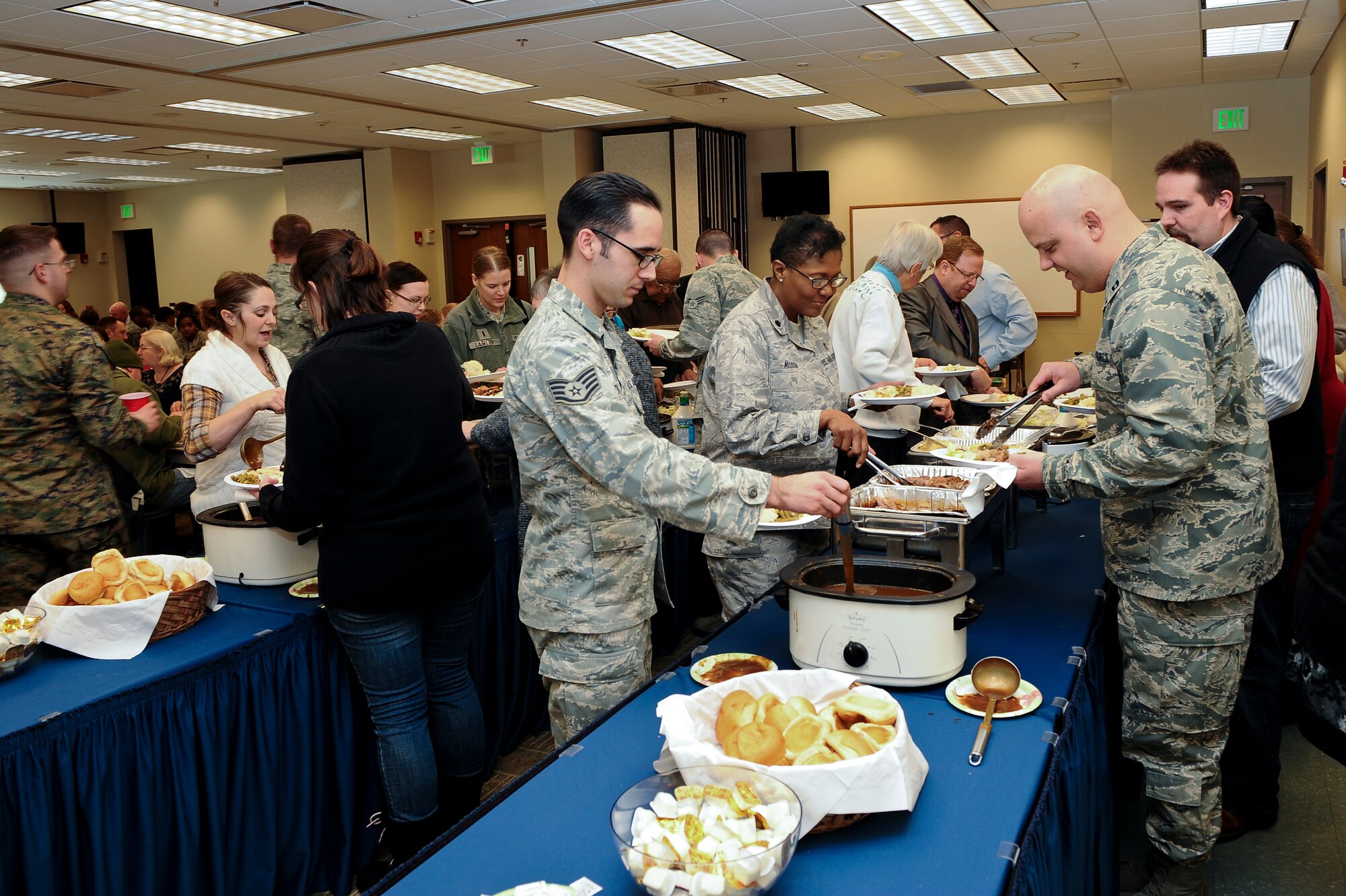 Members of Team Buckley dish up food at the National Prayer Luncheon Feb. 5, 2014, at the chapel on Buckley Air Force Base, Colo. More than 350 Team Buckley members attended the luncheon, an annual event that encourages believers of any religion to seek their God through prayer. (U.S. Air Force photo by Senior Airman Phillip Houk/Released)
