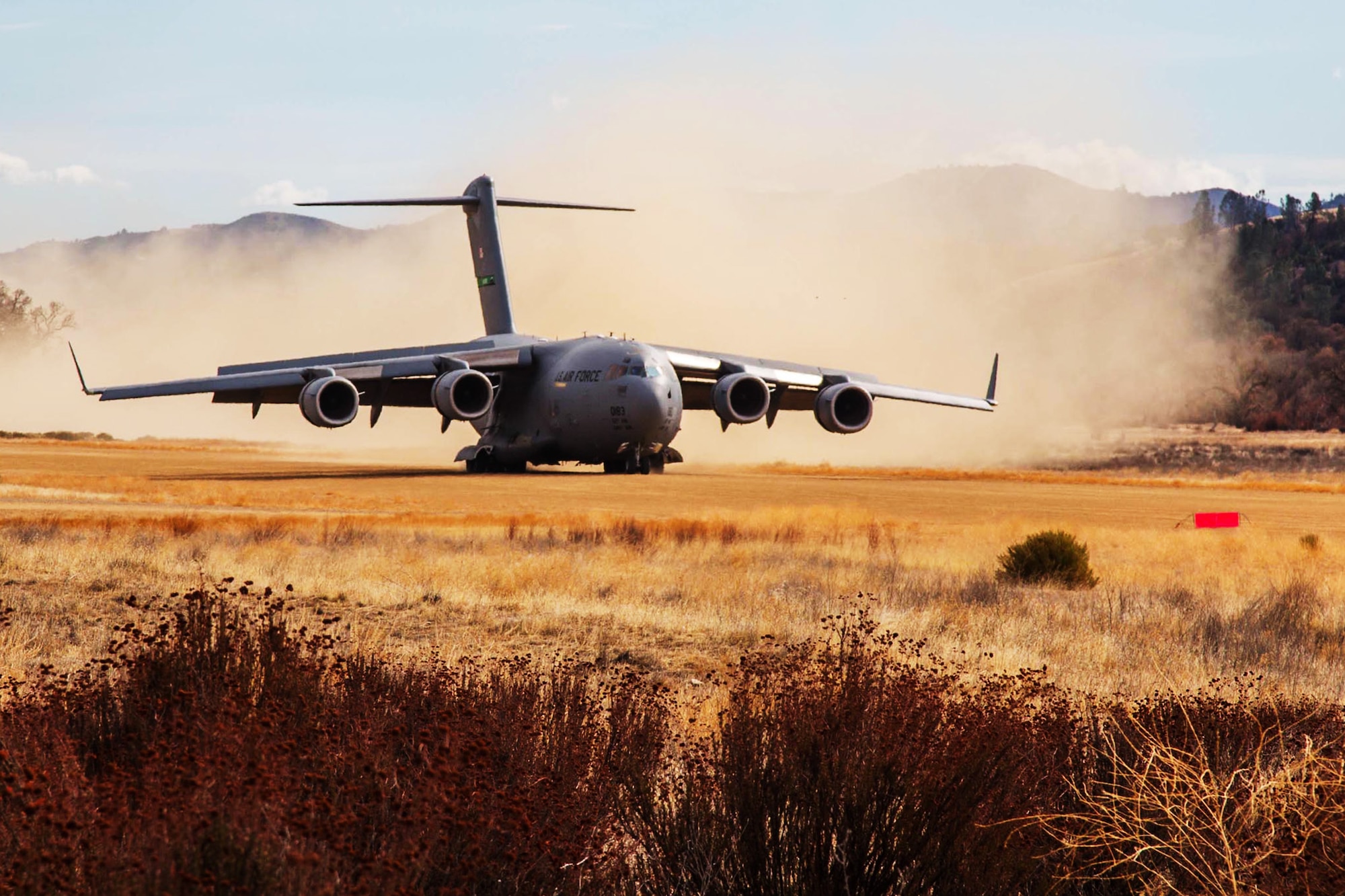 A U.S. Air Force C-17 Globemaster III aircraft lands on Fort Hunter Liggett, Calif., Jan. 31, 2014. This landing was part of a Air Force operation to test fire the M142 High Mobility Artillery Rocket System, (HIMARS). (U.S. Army photo by Private 1st Class Nathaniel Newkirk)