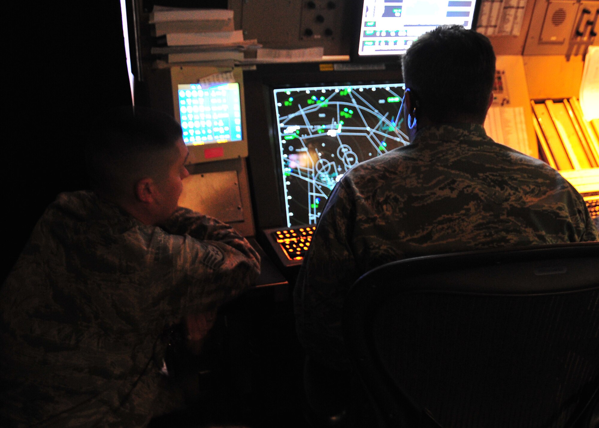 Staff Sgt. Justin Sprayberry, 325th Operation Support Squadron air traffic controller radar approach control watch supervisor, shows Col. David Graff, 325th Fighter Wing commander, how air traffic maneuvers on a monitor Feb. 7, at the RAPCON building. Graff shadows an Airman once a month as part of the Airman Shadow Program to see what it is like on a daily basis of an Airman. (U.S. Air Force photo by Airman 1st Class Sergio A. Gamboa)