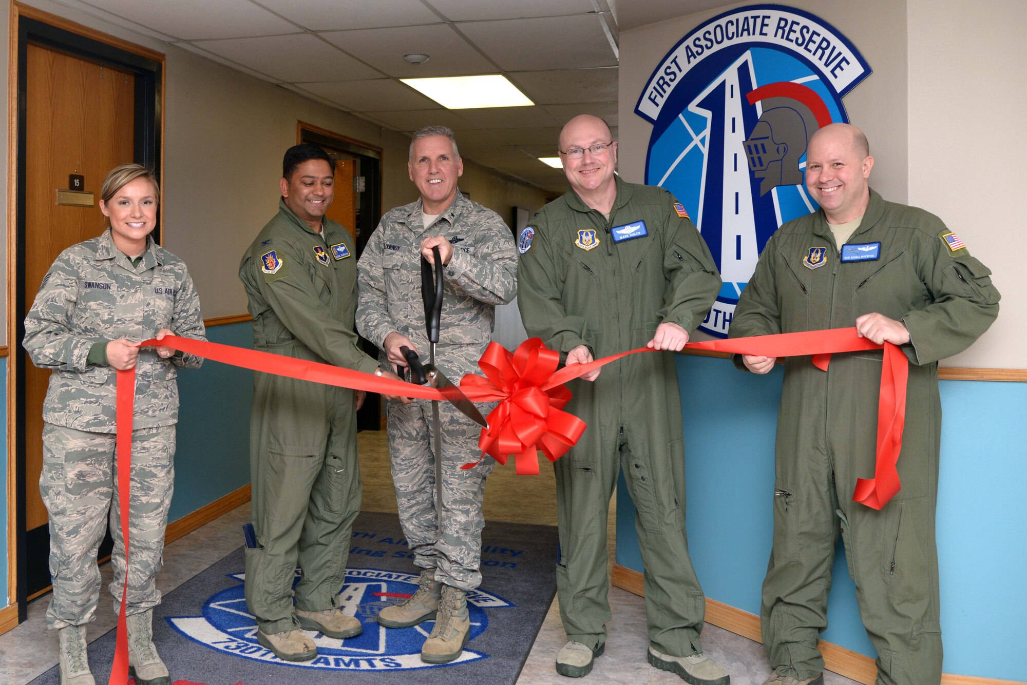 ALTUS AIR FORCE BASE, Okla. – U.S. Air Force Tech. Sgt. Alexandria Swanson, 730th Air Mobility Training Squadron knowledge operations manager; U.S. Air Force Col. Sushil Ramrakha, 97th Air Mobility Wing vice commander; U.S. Air Force Brig. Gen. John Flournoy Jr., 4th Air Force commander; U.S. Air Force Col. Mark Sigler, 452nd Operations Group commander, March Air Reserve Base, Calif.; and U.S. Air Force Master Sgt. Russell Hippensteel, 730th instructor loadmaster, cut a ribbon as part of the opening ceremony for the 730th Air Mobility Training Squadron Feb. 7, 2014. The 730th recently moved into the 58th Airlift Squadron through a self-help project, which cost $1,500. (U.S. Air Force photo by Airman 1st Class Klynne Pearl Serrano/Released)