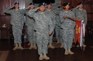Soldiers from the Special Troops Battalion, 7th Transportation Brigade (Expeditionary) salute the 382nd Transportation Theater Opening Element flag during an inactivation ceremony at Fort Eustis, Va., Feb. 6, 2014. The 382nd TTOE began as the 3382nd  Quartermaster Service Detachment in Nov. 1944. (U.S. Air Force photo by Senior Airman Teresa Aber/Released)