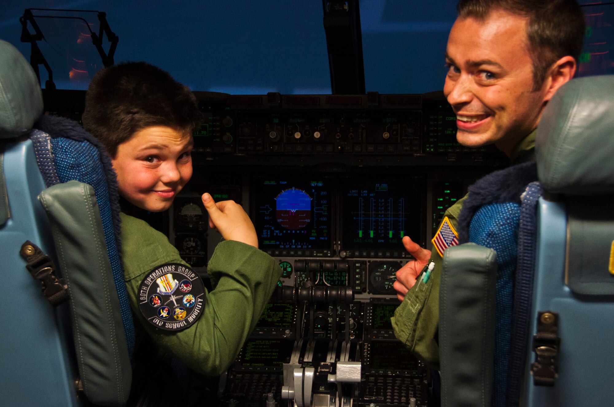 Aircraft commander AJ Calisi and co-pilot Capt. Matt Tarnowski, 21st Airlift Squadron, prepare for their flight to Honolulu Hi. Jan. 31 during Pilot for a Day. (U.S. Air Force photo/Senior Airman Madelyn Brown)
