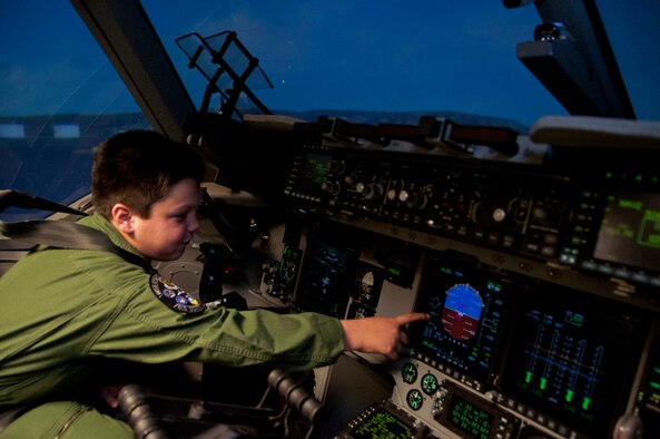 AJ displays his new knowledge of aircraft controls inside the C-17 simulator on Travis Air Force Base Jan. 31 (U.S. Air Force photo/Senior Airman Madelyn Brown)