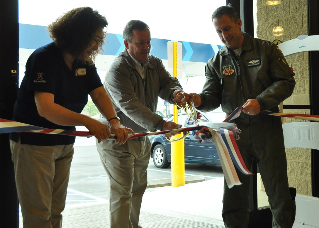 From left to right: Mickey Park, Express store manager, Phillip Capshaw, Base Exchange general manager and Col. Mark O’Laughlin, 325th Fighter Wing vice commander, cut the ribbon for the grand opening of the Tyndall Army and Air Force Exchange Service Express Feb. 6. The Express provides convenience items and fuel for those at Tyndall. (U.S. Air Force photo by Airman 1st Class Solomon Cook)