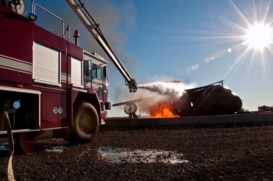 AJ Calisi douses the flames on the training aircraft Jan. 31 as part of his Pilot for a Day experience on Travis Air Force Base. (U.S. Air Force photo/Senior Airman Madelyn Brown)