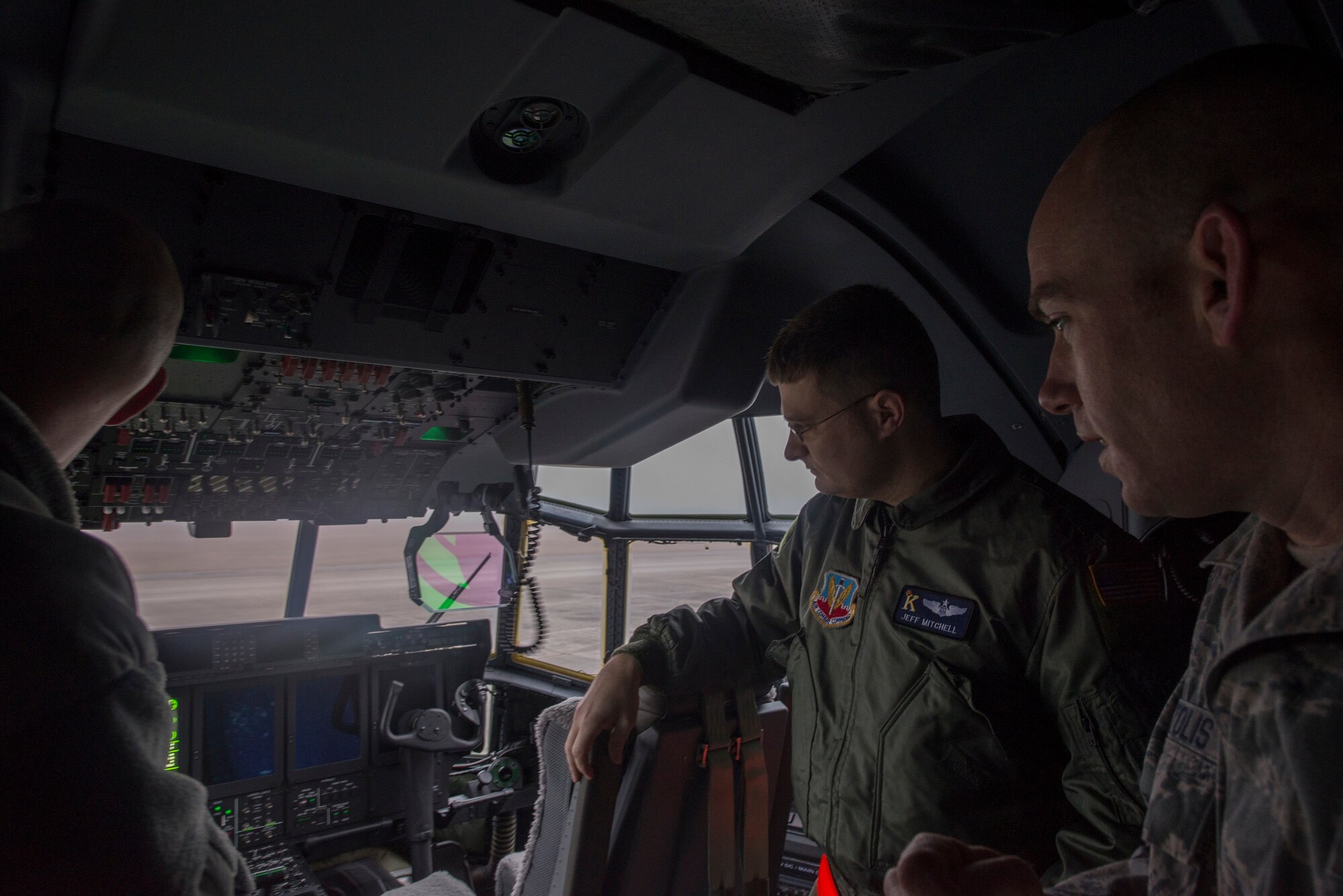 U.S. Air Force Tech Sgt. Matthew Debertolis, right, 723d Aircraft Maintenance Squadron supervisor, listens to a demonstration from Capt. Jeffrey Mitchell, 71st Rescue Squadron radar operator, of an HC-130J Combat King II aircraft during Tour of Champions at Moody Air Force Base, Ga., Jan. 31, 2014. The 23d Wing made the switch from the older HC-130P Combat King to the more technologically advanced C-130 July 2013. (U.S. Air Force photo by Airman Dillian Bamman/Released)