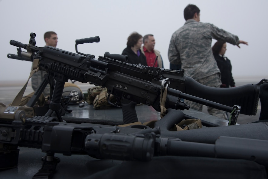 U.S. Air Force Staff Sgt. Alejandro Serrano, 38th Rescue Squadron pararescueman, gives a pararescuemen demonstration during the Tour of Champions at Moody Air Force Base, Ga., Jan. 31, 2014. The M249 light machine gun is one of the weapons pararescuemen use to complete their deployed mission. (U.S. Air Force photo by Airman Dillian Bamman/Released)
