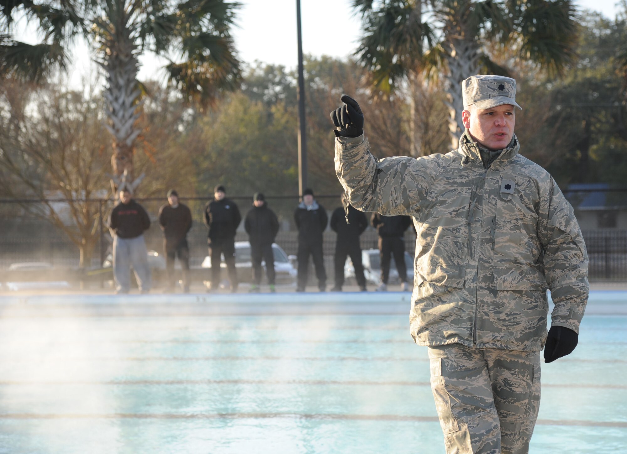 Lt. Col. Kevin Bray, 334th Training Squadron commander, delivers welcoming remarks during the heated triangle pool ribbon cutting ceremony Feb. 7, 2014, at Keesler Air Force Base, Miss.  The heated pool will allow Keesler’s battlefield Airmen students the ability to efficiently execute water skills training without impeding on the limited time the students have in the morning for physical training before starting their academic day.  Prior to the heater being installed, the Airmen had to use an off base facility.  (U.S. Air Force photo by Kemberly Groue)