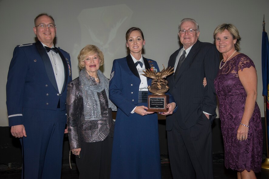 U.S. Air Force Tech. Sgt. Jacqueline Haro, 23 Maintenance Group, center, receives the first Parker and Dr. Lucy Greene Exceptional Service Award at Moody Air Force Base, Ga., Jan. 31, 2014. Haro received the award for her work with the Air Force Sergeants Association in addition to her work in the 23d MXG. (U.S. Air Force photo by Airman Dillian Bamman/Released)