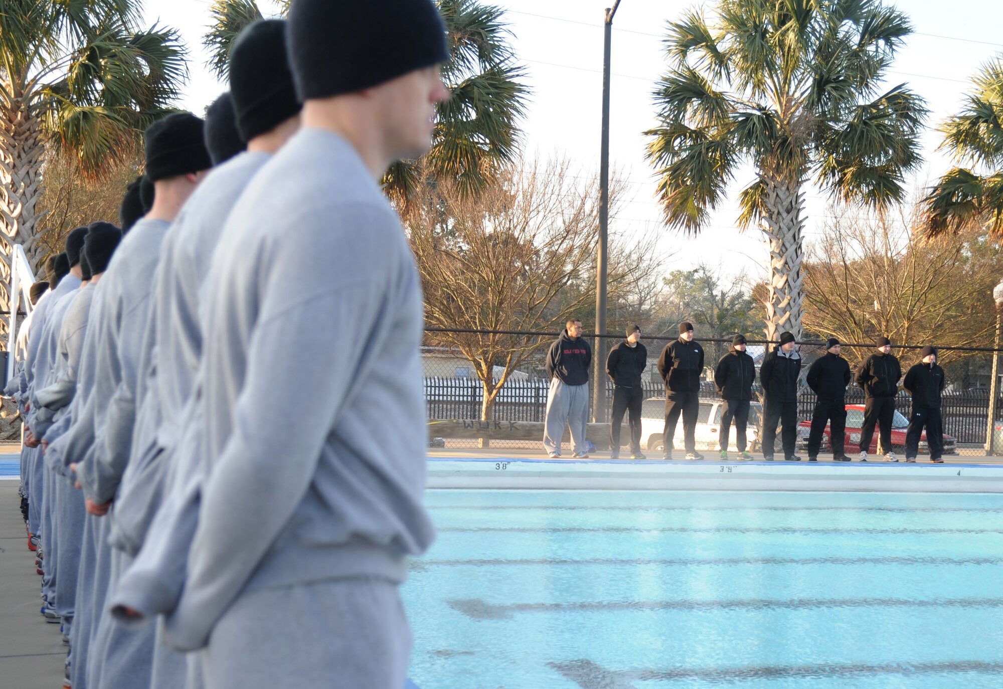 Combat Control Airmen and instructors from the334th Training Squadron stand near the edge of the newly heated triangle pool facility prior to the ribbon cutting ceremony Feb. 7, 2014, at Keesler Air Force Base, Miss.  The heated pool will allow Keesler’s battlefield Airmen students the ability to  execute water skills training without  impeding on the limited time the students have in the morning for physical training before starting their academic day.  Prior to the heater being installed, the Airmen had to use an off base facility.  (U.S. Air Force photo by Kemberly Groue)