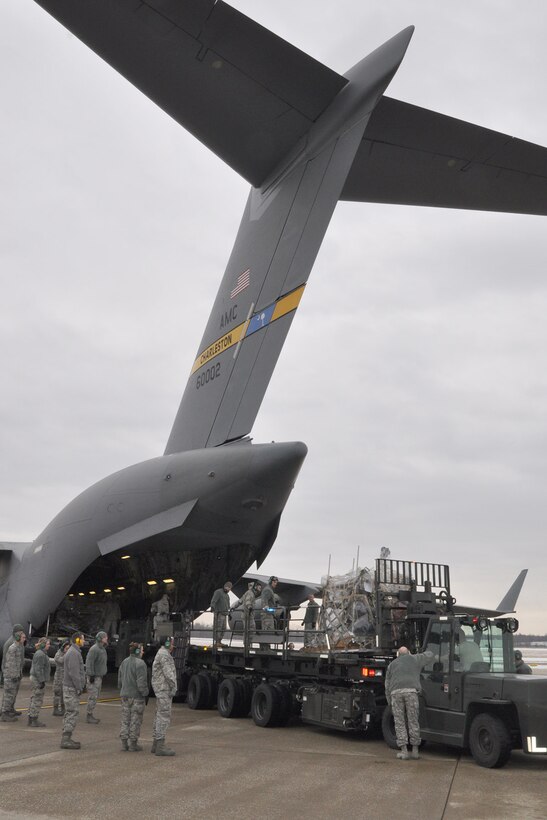 YOUNGSTOWN AIR RESERVE STATION, Ohio - U.S. Air Force Reserve Citizen Airmen, assigned to the 910th Airlift Wing’s 76th Aerial Port Squadron (APS), use a 60-K cargo loader to move humanitarian cargo, collected by MedWish International, onto a C-17 Globemaster cargo aircraft on the flightline here, Feb. 1, 2014. The 76th APS team previously palletized the Honduras-bound cargo. The shipment was transported through the Denton program which allows non-governmental agencies to use military airlift for humanitarian purposes. U.S. Air Force photo by Master Sgt. Bob Barko Jr.  
