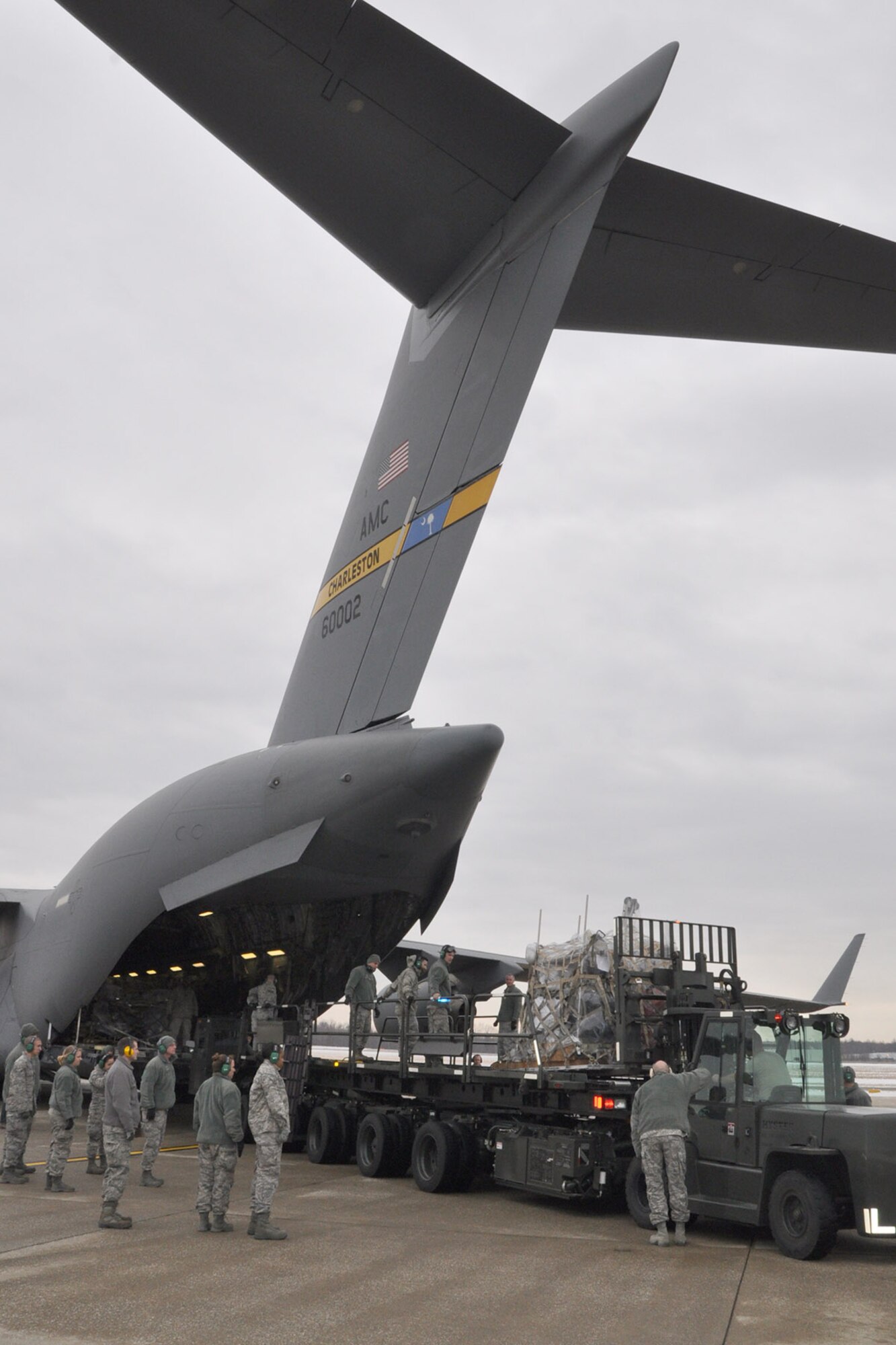 YOUNGSTOWN AIR RESERVE STATION, Ohio - U.S. Air Force Reserve Citizen Airmen, assigned to the 910th Airlift Wing’s 76th Aerial Port Squadron (APS), use a 60-K cargo loader to move humanitarian cargo, collected by MedWish International, onto a C-17 Globemaster cargo aircraft on the flightline here, Feb. 1, 2014. The 76th APS team previously palletized the Honduras-bound cargo. The shipment was transported through the Denton program which allows non-governmental agencies to use military airlift for humanitarian purposes. U.S. Air Force photo by Master Sgt. Bob Barko Jr.  