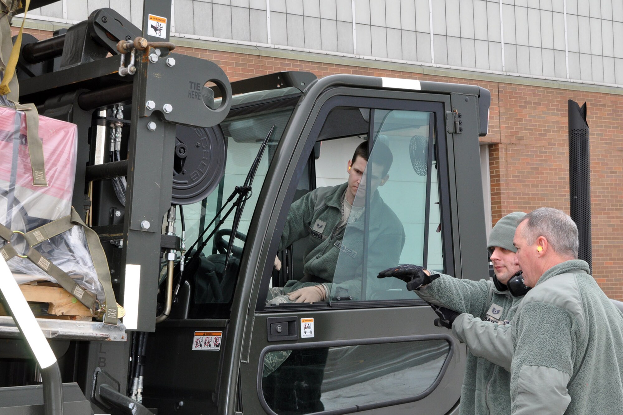 YOUNGSTOWN AIR RESERVE STATION, Ohio - U.S. Air Force Reserve Senior Airman Trevor Merrow, an air transportation specialist assigned to the 910th Airlift Wing’s 76th Aerial Port Squadron (APS), operates a forklift to load cargo onto a 60-K cargo loader outside of the APS hangar here, Feb. 1, 2014. Citizen Airmen from the 76th APS palletized and loaded humanitarian cargo, collected by MedWish International, onto a C-17 Globemaster cargo aircraft at YARS. The cargo was bound for Honduras and was transported through the Denton program which allows non-governmental agencies to use military airlift for humanitarian purposes. U.S. Air Force photo by Master Sgt. Bob Barko Jr.