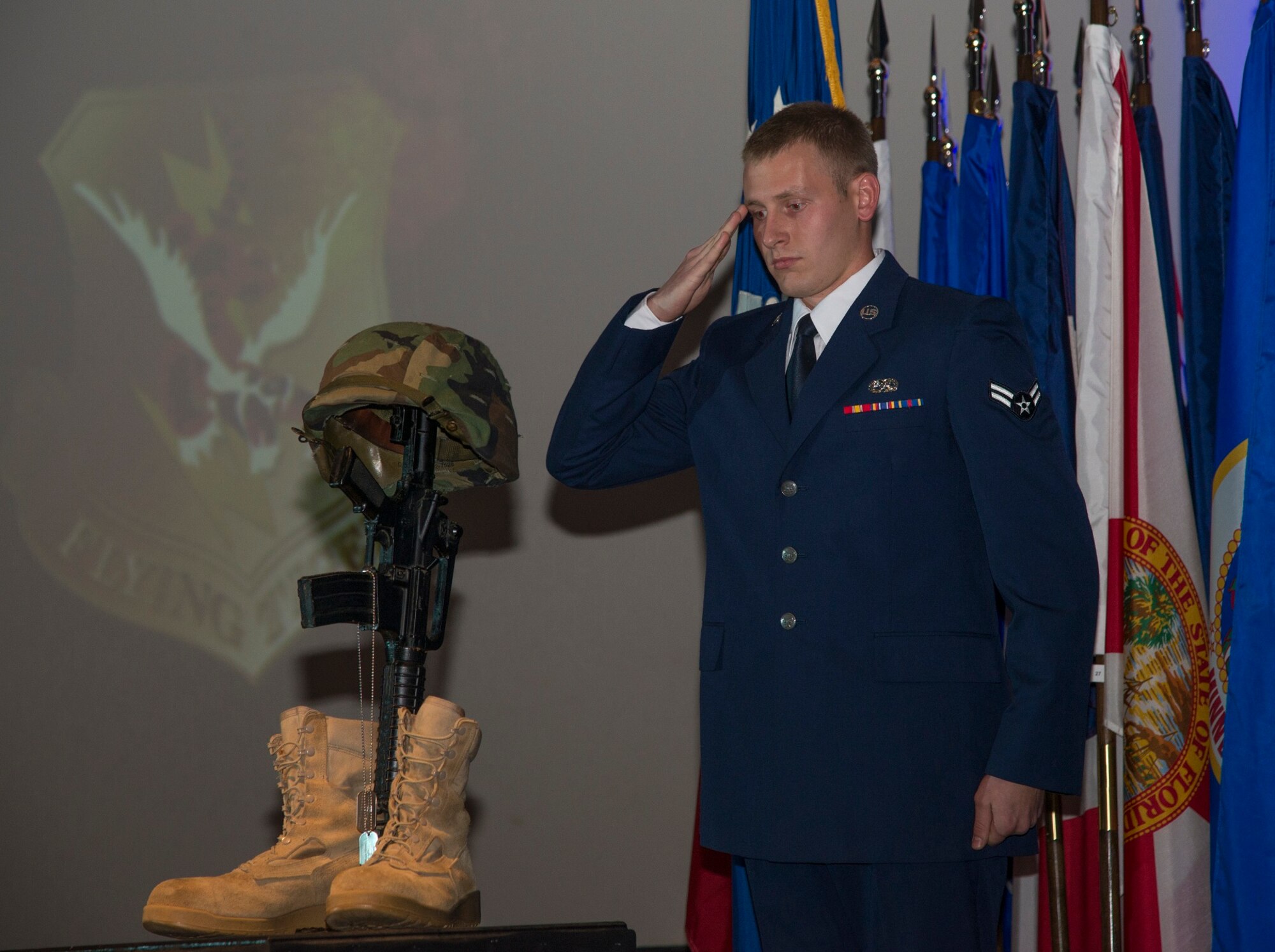 U.S. Air Force Airman 1st Class Andrew Trosper, 723d Aircraft Maintenance Squadron, salutes the Fallen Warrior Memorial after placing a set of dog tags on the memorial during the Annual Awards ceremony at Moody Air Force Base, Ga., Jan. 31, 2014. The memorial represents deployed Airmen from the 23d Wing and 93d Air Ground Operations Wing who have been killed in action. (U.S. Air Force photo by Airman Dillian Bamman/Released)