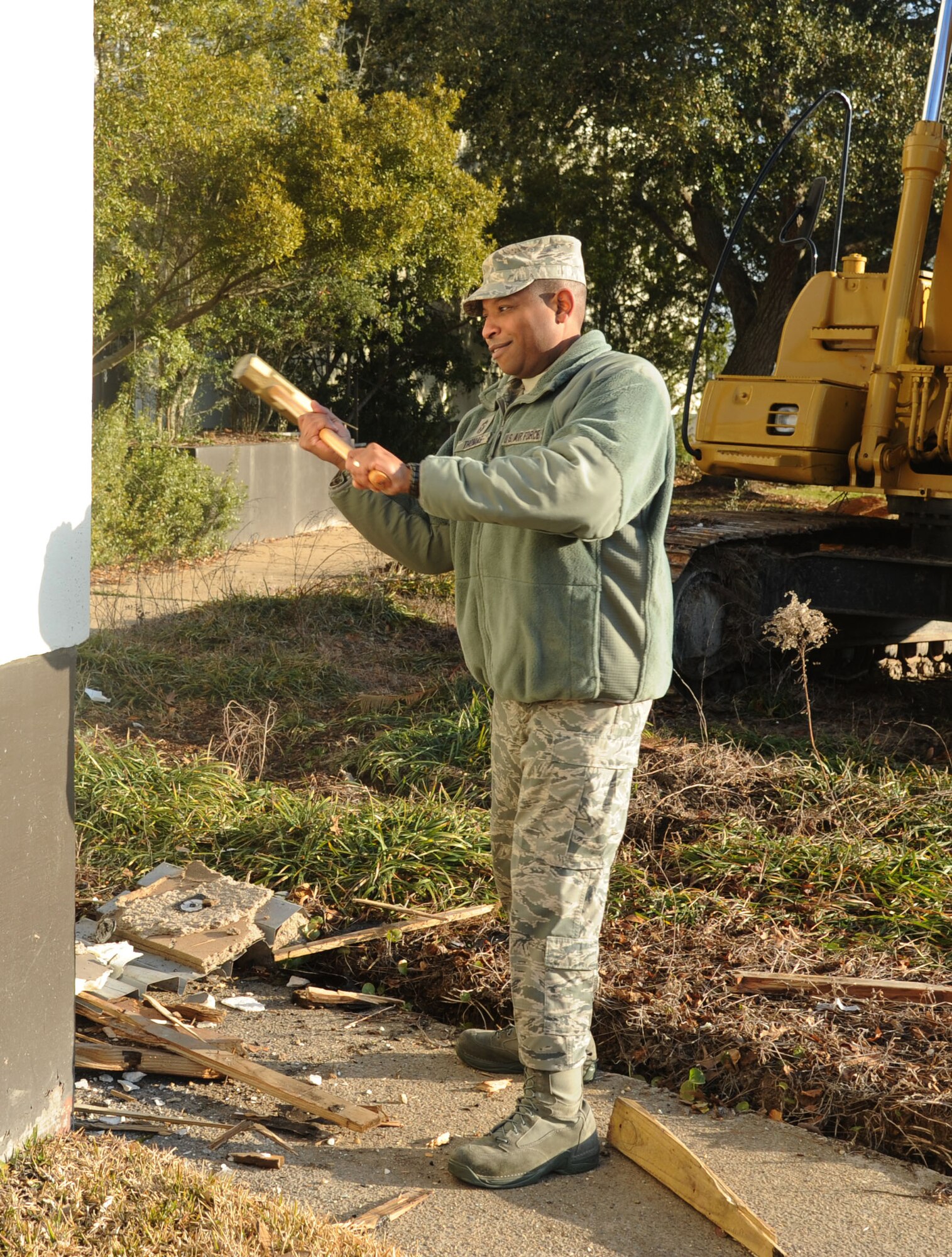 Chief Master Sgt. Farrell Thomas, 81st Training Wing command chief, uses a sledge hammer to put a dent in the outside wall of Garrard Hall Feb. 7, 2014, at Keesler Air Force Base, Miss., before the building’s demolition is continued.  The estimated completion date is by the end of May and the property will be returned to green space.  (U.S. Air Force photo by Kemberly Groue)