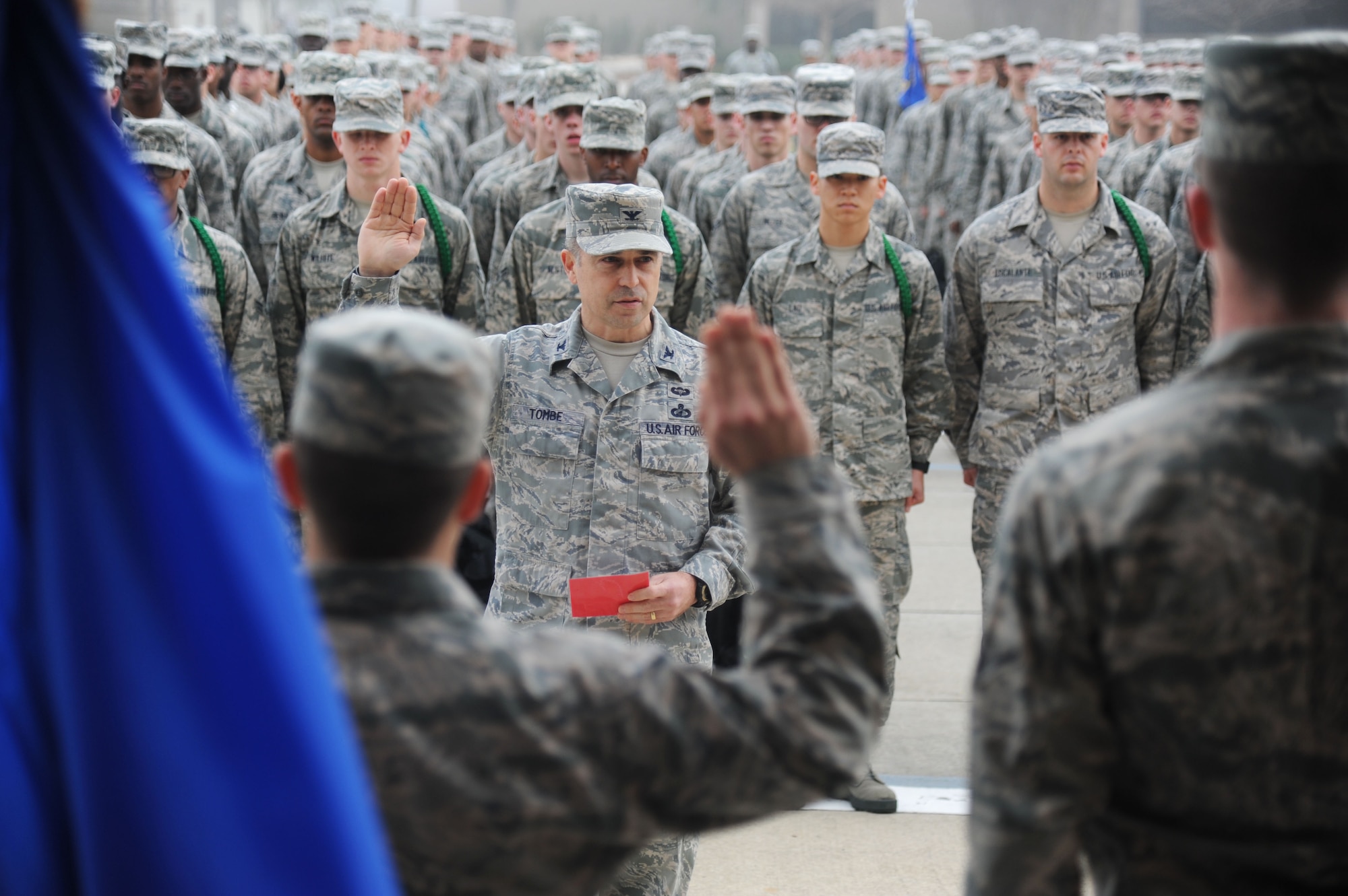 Col. George Tombe, 81st Training Group commander, administers the oath of enlistment to seven of the Training Group’s newest Airmen promotees during a dragon recognition presentation Feb. 4, 2014, behind the Levitow Training Support Facility, Keesler Air Force Base, Miss.  The ceremony reinforced their commitment as they take on new responsibilities with their promotion. The event also included the announcements of Airman of the Month and military training flight of the Month for January.  (U.S. Air Force photo by Kemberly Groue)