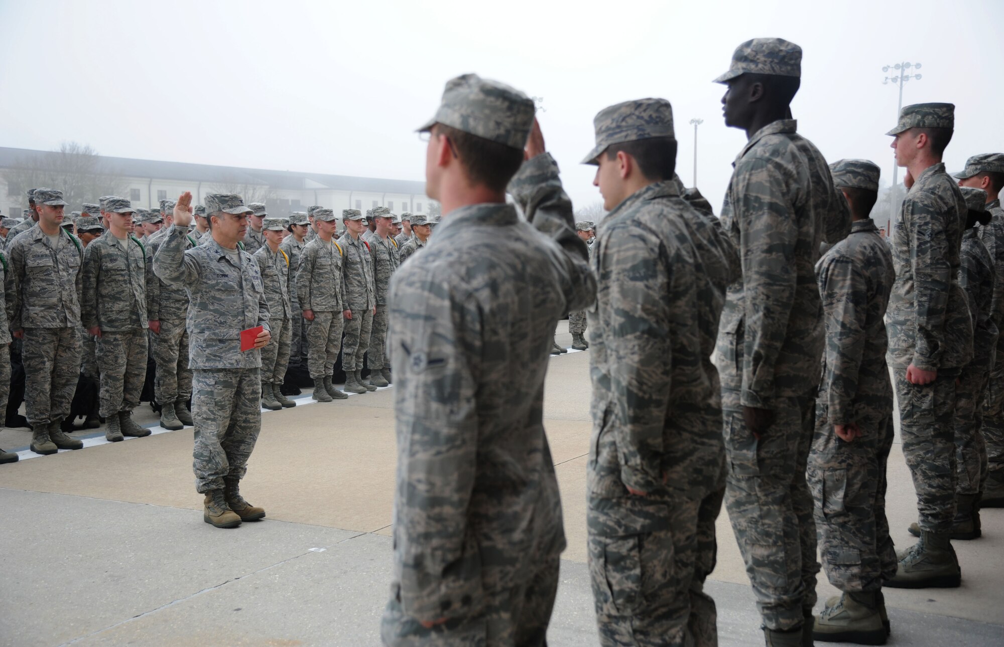 Col. George Tombe, 81st Training Group commander, administers the oath of enlistment to seven of the Training Group’s newest Airmen promotees during a dragon recognition presentation Feb. 4, 2014, behind the Levitow Training Support Facility, Keesler Air Force Base, Miss.  The ceremony reinforced their commitment as they take on new responsibilities with their promotion. The event also included the announcements of Airman of the Month and military training flight of the Month for January.  (U.S. Air Force photo by Kemberly Groue)