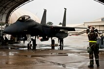 An Airman assigned to the 4th Aircraft Maintenance Squadron marshals an F-15E Strike Eagle during Employment Exercise Coronet Warrior 14-01, Feb. 5, 2014, at Seymour Johnson Air Force Base, N.C.  The two-day exercise assessed Airmen readiness to complete the mission in a deployed environment.  (U.S. Air Force photo by Airman 1st Class Brittain Crolley)